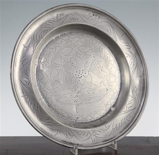 An 18th century pewter dish, 13.25in.